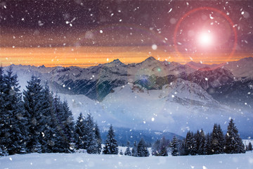 Christmas background with snowy fir trees and mountains in heavy blizzard.