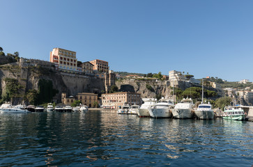 Fototapeta na wymiar View of Marina and hotels on the cliffs in Sorrento. Gulf of Naples, Campania, Italy