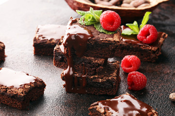 chocolate brownie cake dessert with raspberries and spices on a wooden background.