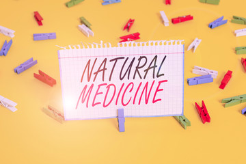 Writing note showing Natural Medicine. Business concept for any of various systems of healing or treating disease Colored clothespin papers empty reminder yellow floor background office