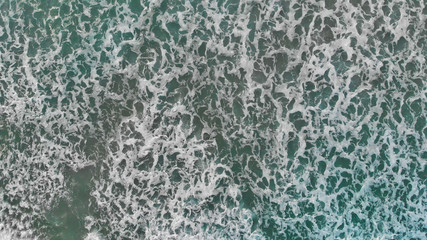 Aerial looking straight down onto large swell and waves. Overhead downward view of sea waves