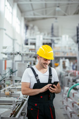 Factory worker in uniform with phone