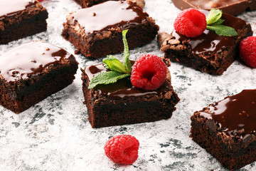 chocolate brownie cake dessert with raspberries and spices on a wooden background.