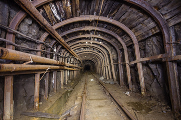 Fototapeta na wymiar Gold iron mine ore shaft tunnel drift with timbering