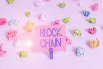 Writing note showing Block Chain. Business concept for system in which a record of transactions made in bitcoin Colored crumpled paper empty reminder white floor clothespin