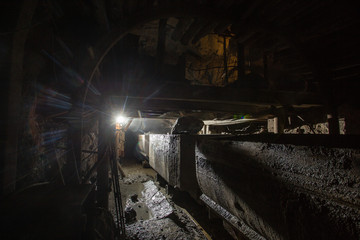 Fototapeta na wymiar Gold iron mine shaft loading ore to car wagon