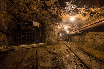 Naklejka premium Gold iron mine ore shaft tunnel drift with rails underground