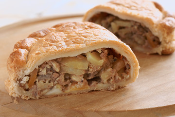 Traditional English Cornish pasty filled with meat potatoes and swede