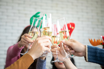 Friends celebrating Christmas or New Year eve party with champagne