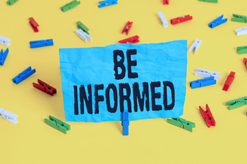 Conceptual hand writing showing Be Informed. Concept meaning having or showing knowledge of a subjects or situations Colored clothespin papers empty reminder yellow floor office