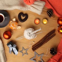 beautiful flat on a wooden natural table with a cup of coffee, tea, mulled wine, with peeled mandarin, sweets, cones, decorated with decorations,, the concept of Christmas and New Year, cozy home