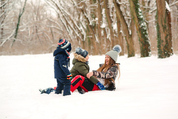 Fototapeta na wymiar Family playing with snow in winter park