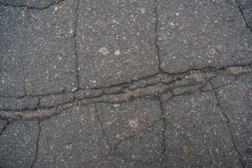 Obraz premium The surface of the old asphalt cracked