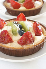 Fruit tarts filled with strawberries, kiwi fruit and blueberries