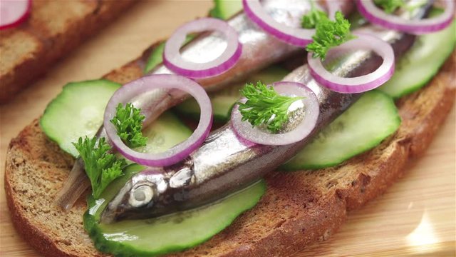 put fresh parsley on sandwich with salted capelin cucumber rye bread red onion
