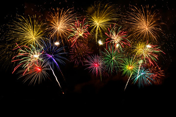 Colorful fireworks celebration on midnight sky.
