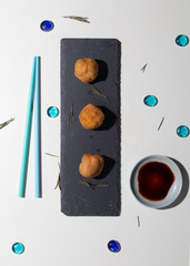 fried japanese tofu with colorful chopsticks on the table, white background