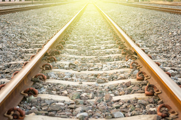 Railroad tracks at sunset. Railroad tracks heading straight ahead.