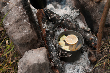 Aromatic and hot herbal tea  on campfire	