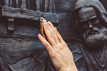 the bronze hand of the monument polished to a Shine