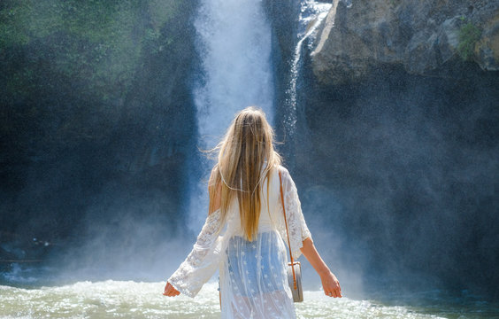 Girl On The Background Of A Waterfall