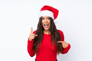 Girl with christmas hat over isolated white background with surprise facial expression