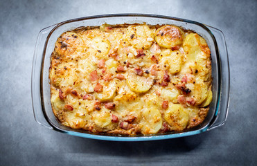 Freshly cooked casserole with potatoes, bacon and cheese close-up on the table top view