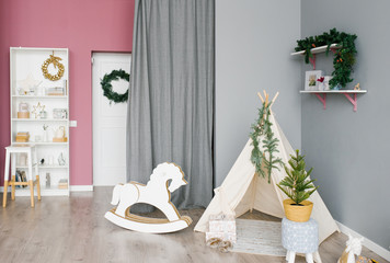 Children's room, decorated for Christmas and New year in pink and gray tones