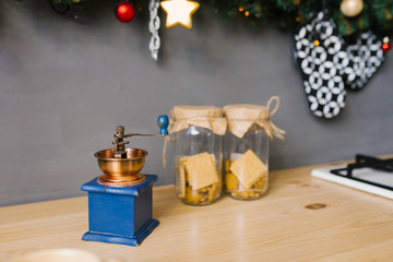 Coffee grinder and two glass jars of cookies in the kitchen