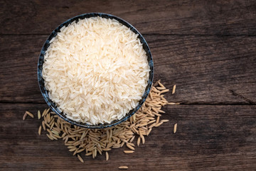 Parboiled rice ligth colour uncook and paddy rice. Close up shot. Top view.