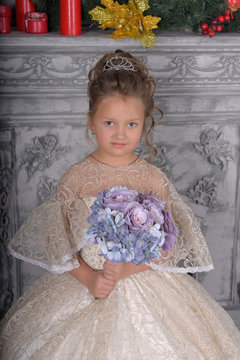 little girl in elegant white Victorian dress in the interior