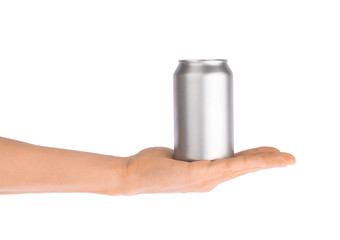 Hand holds metal beverage drink can isolated on white