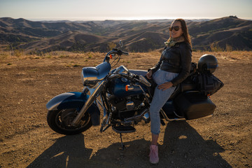 Woman biker sitting on her motorcycle