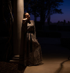 Naklejka premium Lady in beautiful dress posing outdoor at night