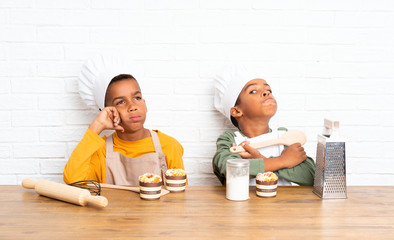 Two African American brothers kids dressed as chef and thinking