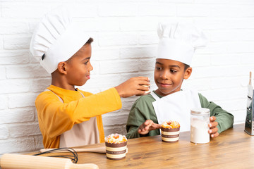 Two African American brothers kids dressed as chef