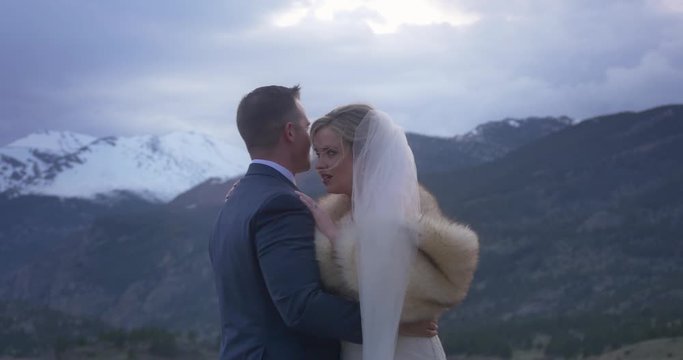 A couple kiss and rock together at their mountain elopement