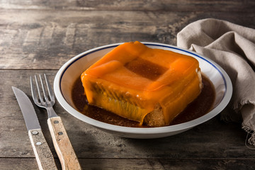 Typical Portuguese francesinha sandwich on wooden table