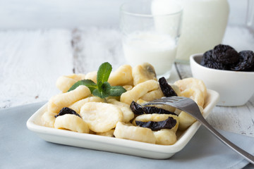   Save Download Preview Lazy pierogi dumplings with sour cream and dry plums. and glass of milk. ...