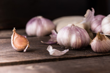 Organic Garlic bulb and garlic cloves on the wooden table in the garden.