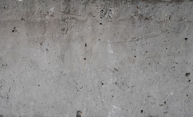 Texture of old concrete wall for background. White concrete wall background with a cracks nad holes.
