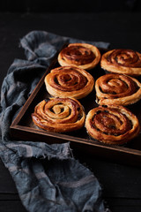 Fresh danish pastry with raisins on wood background.Tasty sweet bakery.