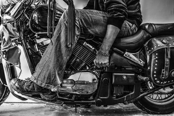 biker starting a motorcycle in black and white