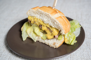 Half hamburger with meat, lettuce and mustard