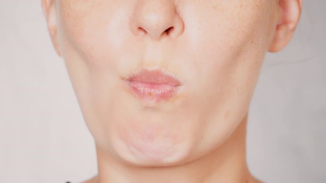 lower face caucasian female with freckles eats croissant portrait lady bites and chews