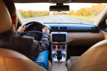 The man driving the modern car