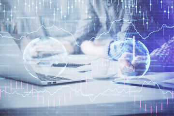 Multi exposure of forex chart with man working on computer on background. Concept of market analysis.