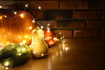 Halloween decoration - butternut squash pumpkin with warm white led lights in background