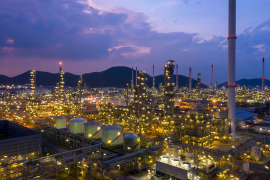 Aerial view of twilight petrochemical oil refinery plants,sea industrial engineering concept at night, Oil and gas tanks pipelines in industry. Modern metal factory. Crude Oil Production.