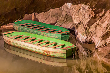 Boats anchored on a small dock in  underground cave in Aywaille, Belgium